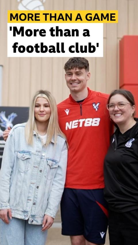 Jorgen Strand Larsen stood with a fan and a member of the community trust