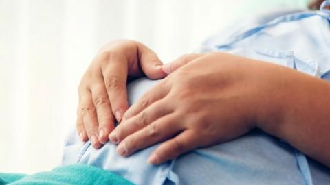 Pregnant woman lying on the bed waiting to give birth in a hospital