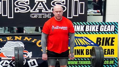 Glen Bailey lifting weights