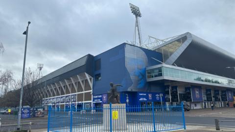 A general view of Ipswich Town Football Club's Portman Road stadium. A statue of a former player sits in the foreground.