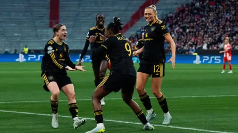 Malard celebrates with Manchester Utd team mates