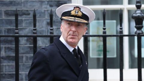 Admiral Sir Tony Radakin walking outside Downing Street, wearing his uniform. 
