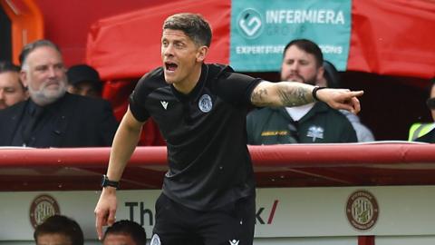 Alex Revell points with his left index finger as he urges his Stevenage team on in the play-off first leg against Stockport