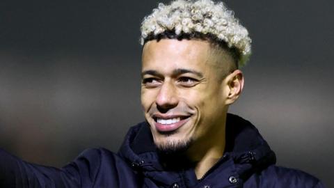 Lyle Taylor looks on