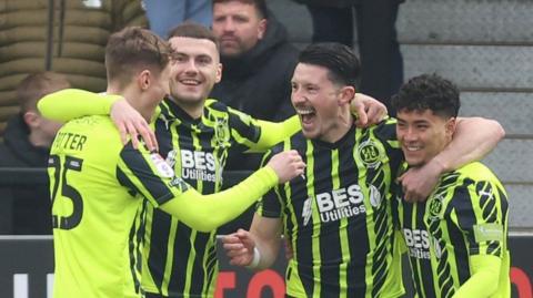 Fleetwood celebrate Ronan Coughlan's opening goal at Salford