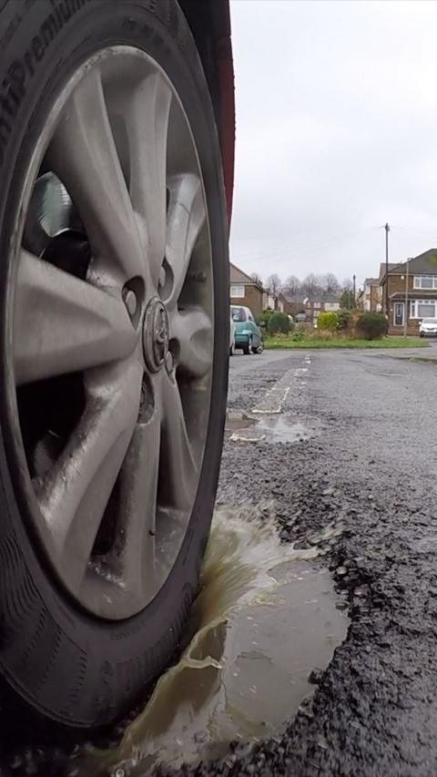 Tyre driving through pothole