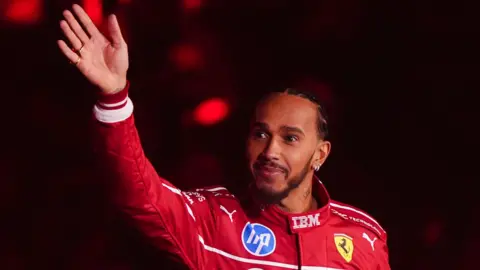 Lewis Hamilton waves to the crowd at the O2 Arena