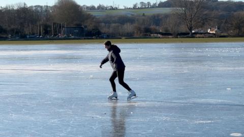A woman ice skates on Oxford's Port Meadow.