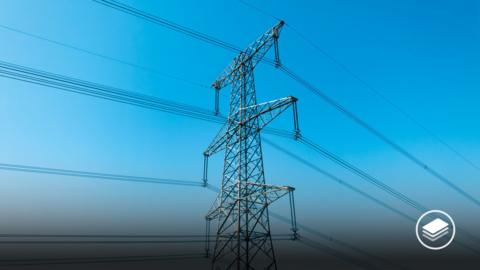 An electricity pylon with a blue sky.