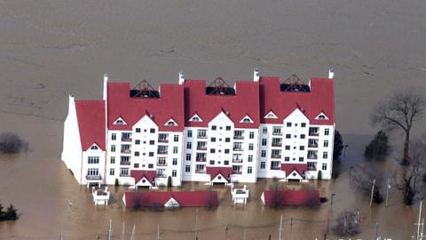 Aerial shot of buildings surrounded by flood water in Louisville, Kentucky