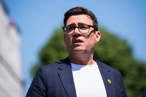 Andy Burnham in a white t-shirt and blue blazer 