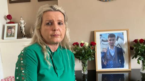 Tatiana Qureshi sat in front of pictures of her son Temur