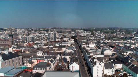 A drone shot of a number of buildings and homes in Jersey. 