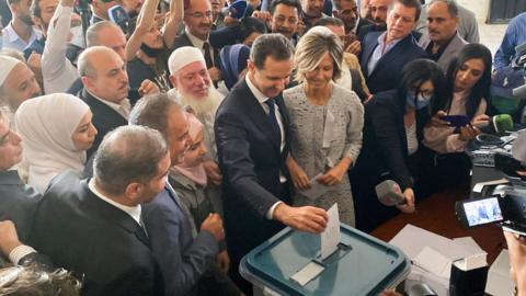 Bashar al-Assad and his wife Asma vote in Syria's presidential election in Douma, near Damascus, on 26 May 2021