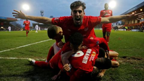 Kidderminster's players celebrate scoring against Reading in the FA Cup