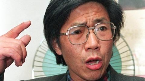 Chinese dissident Qin Yongmin gestures during a press conference in Beijing on 17 November, 1993