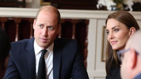 Prince and Princess of Wales talk to volunteers