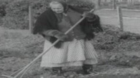 1965 image of Woman gardening at Penrhos Polish Home, Pwllheli, Gwynedd