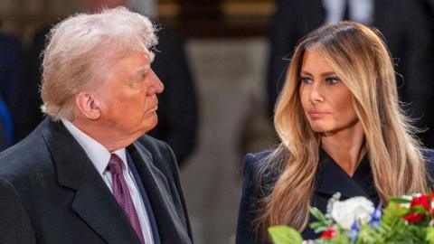 President-elect Donald Trump and his wife Melania stare at each other in a close-up.