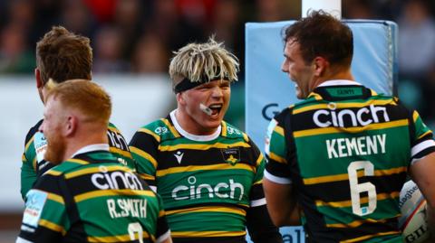 Northampton players celebrate a try