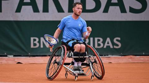 Alfie Hewett holds up his fist in celebration