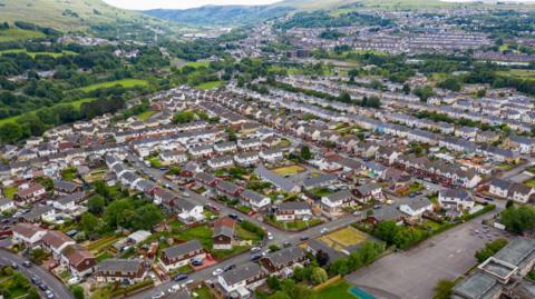 Aerial drone view of houses and green hills in Ebbw Vale in south Wales
