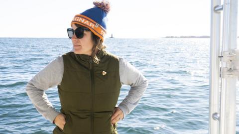 Kelp farmer Suzie Flores sitting on her boat