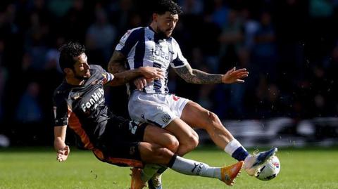 Lewis Travis tackles Alex Mowatt