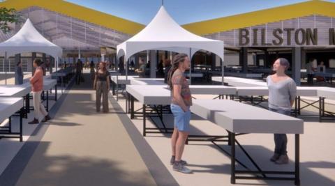 Four people are standing near white tables in the foreground. In the background, the wavy-shaped canopy is yellow and the word Bilston is visible below it on the right-hand side.