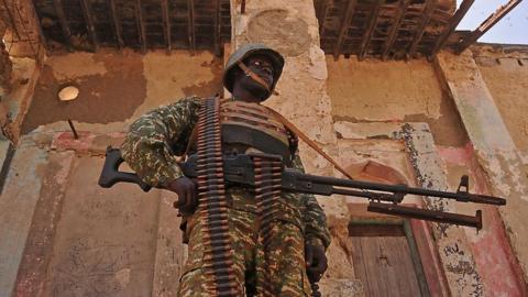 A Ugandan soldier patrols a back street in the southern town of Merka, 90kms north of Somalia"s capital Mogadishu, on 17 July 2016.