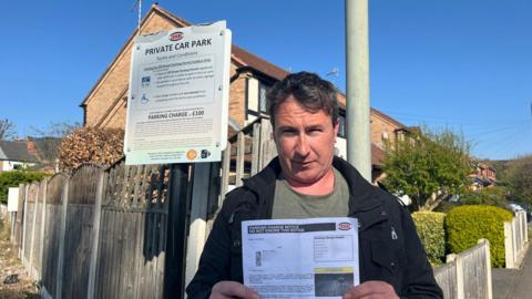 Martin Leighton stood next to the private car park on Broad Oak Drive.
