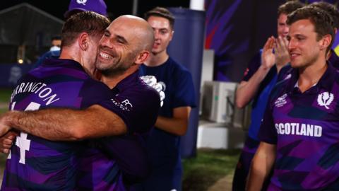 Richard Berrington and Kyle Coetzer of Scotland embrace following the ICC Men's T20 World Cup match between Oman and Scotland