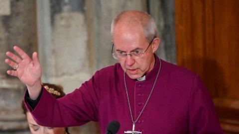 Justin Welby with his hand outstretched