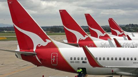 A mixture of Qantas aircraft parked on one of the three runways in Sydney, Australia.