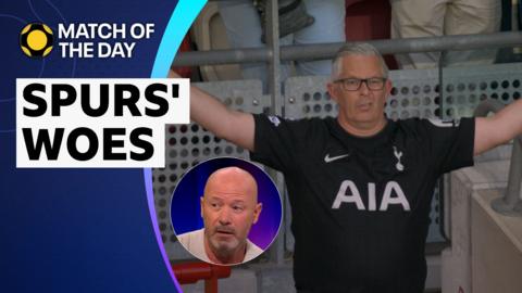 A Tottenham Hotspur fan holds his hands up with a disgruntled look on his face, as Alan Shearer talks