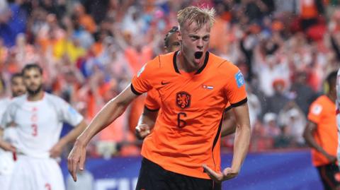 Jan-Paul van Hecke #6 of Netherlands celebrates scoring his team's third goal against Tunisia