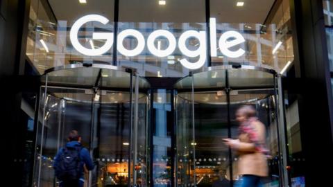 People walk past Google's UK headquarters in London on November 1, 2018