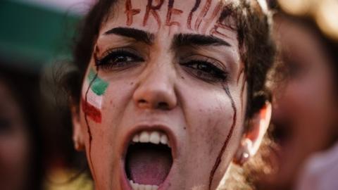A demonstrator with the word "Freedom" in German on her forehead rallies in Berlin, Germany. Photo: 22 October 2022
