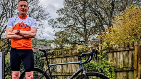 Scott Mitchell stood next to his bike after cycling the challenge