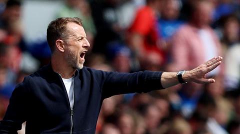 Gary Rowett points directions to his Birmingham City players from the touchline in 2024