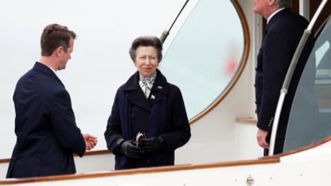 Princess Anne looks on from the boat at the Royal Yacht Squadron