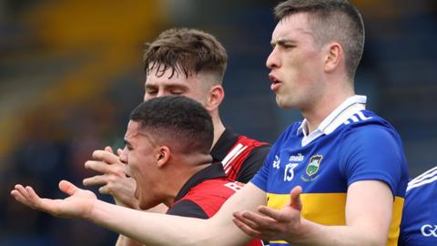 Tipp's Mark Russell protests after conceding a free against Down