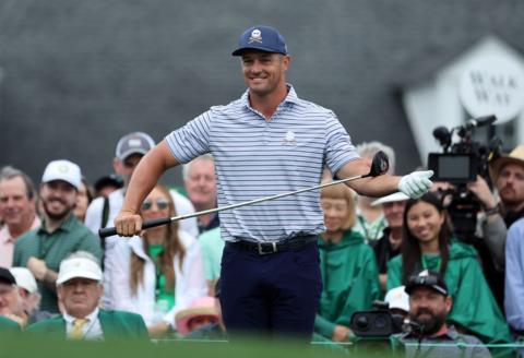 Bryson DeChambeau smiles as he holds his driver during the opening round of the 2024 Masters