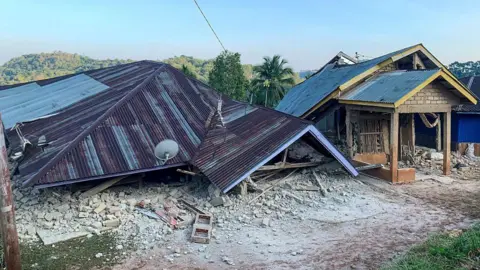 Damaged houses are seen following a 7.7-magnitude earthquake in Ruteng, Manggarai, East Nusa Tenggara, on August 15, 2026. A strong 7.7-magnitude earthquake struck off Flores island in eastern Indonesia early on August 15, the US Geological Survey and Indonesian authorities said, triggering a tsunami warning and prompting hundreds to evacuate