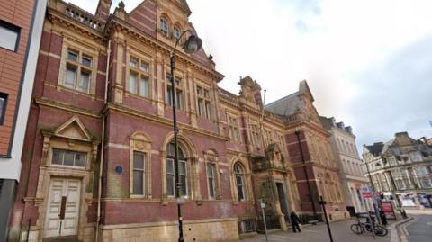 The exterior of the former Grand Post House, which is mainly built from red brick and sand-coloured stone surrounds for the windows