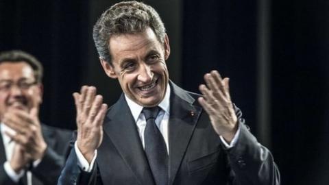 The president of the French right-wing UMP opposition party, Nicolas Sarkozy, greets militants during a meeting in Rilleux-la-Pape on May 21, 2015.