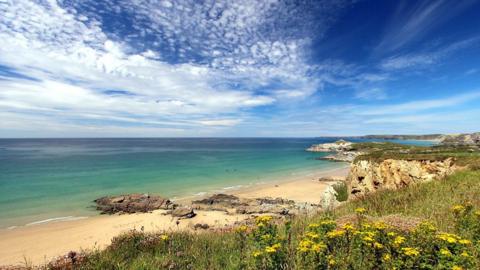 Sunshine and high cloud over the beach at Porth, Cornwall. Picture by BBC Weather Watcher 'Jules'