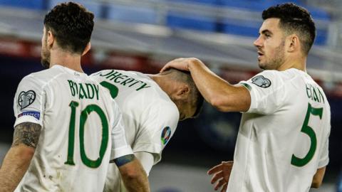 Republic of Ireland players John Egan and Robbie Brady commiserate with Matt Doherty after his penalty miss