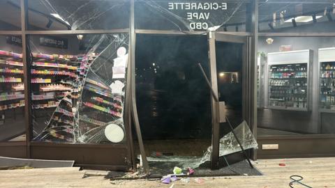 Smashed glass frontage of vape shop