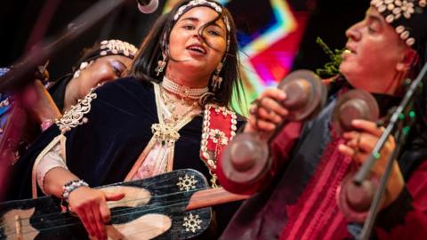 This photo taken on June 24, 2023 shows Moroccan artist Asmaa Hamzaoui, a female member of a traditional Gnawa band, performing during the 24th edition of the Gnaoua World Music Festival in Essaouira